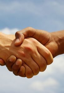 Two young businessmen shaking hands