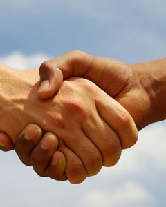 Two young businessmen shaking hands